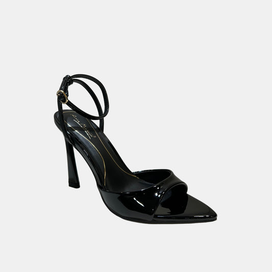 Black high-heeled shoe on a white surface with a neutral background