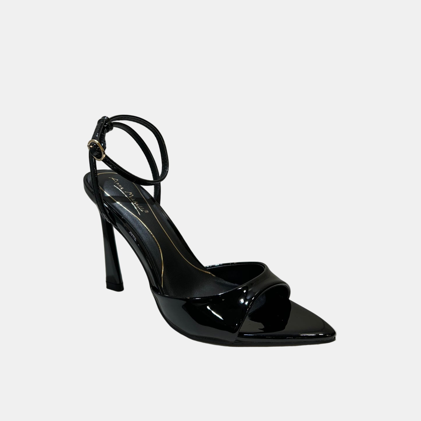 Black high-heeled shoe on a white surface with a neutral background