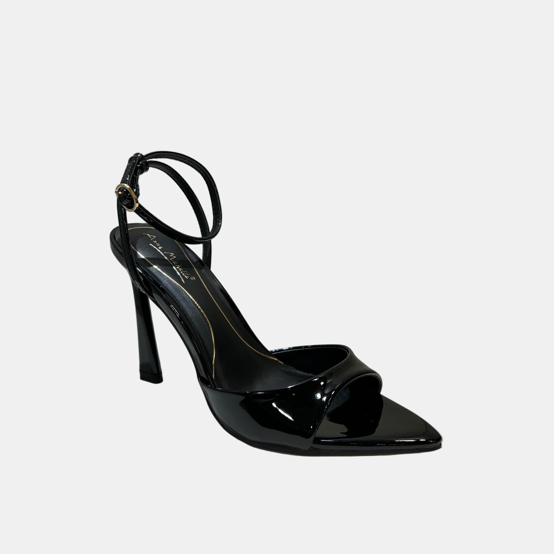 Black high-heeled shoe on a white surface with a neutral background