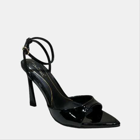Black high-heeled shoe on a white surface with a neutral background